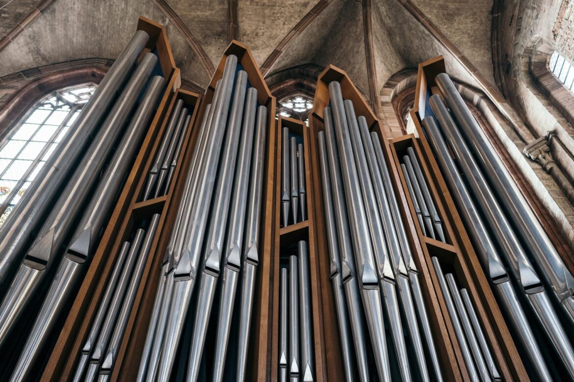 Organ Instrument: How Air Keeps Its Notes Sounding Tall ranks of metal organ pipes beneath Gothic arches in a Nuremberg cathedral.